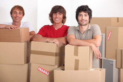 Commercial movers handling desks and IT equipment during an office move