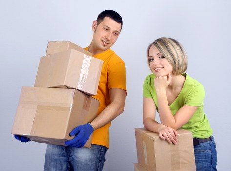 Professional movers handling furniture in a London apartment