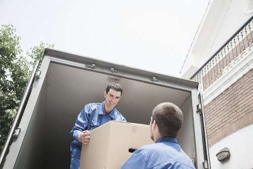 Removal staff using PPE and moving equipment during transit